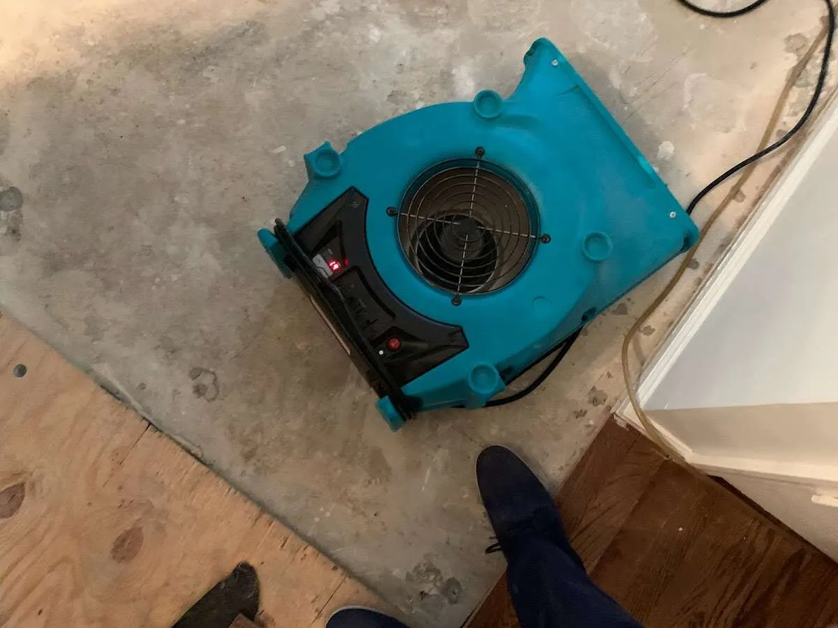 Air mover drying subfloor during Commercial Water Damage Restoration in Prosper